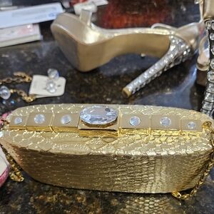 Elegant Gold Clutch with Textured Surface and Sparkling Embellishments